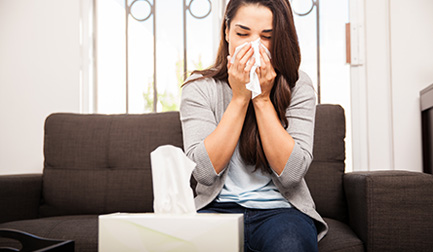 A woman suffers from allergies because of the poor air quality in her home.
